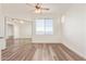 Bright bedroom with wood flooring, fan, mirrored closet doors, and large window at 1701 E Colter St # 491, Phoenix, AZ 85016