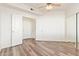 An expansive bedroom features wood floors, closet with mirrored sliding doors, and ceiling fan at 1701 E Colter St # 491, Phoenix, AZ 85016
