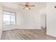 Bedroom with a ceiling fan, a large window, and wood-look floors at 1701 E Colter St # 491, Phoenix, AZ 85016