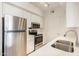 Bright kitchen featuring stainless steel appliances, white cabinets, and quartz countertops at 1701 E Colter St # 491, Phoenix, AZ 85016