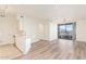 Open living room with wood floors flows to a kitchen area and a sliding glass door with balcony at 1701 E Colter St # 491, Phoenix, AZ 85016