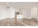 Bright living room featuring wood floors and an open-concept kitchen with stainless steel appliances at 1701 E Colter St # 491, Phoenix, AZ 85016