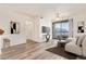 This staged living room features a sofa, large windows, and a television at 1701 E Colter St # 491, Phoenix, AZ 85016