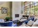 Cozy lounge featuring a fireplace, piano, large windows, and comfortable seating at 1701 E Colter St # 491, Phoenix, AZ 85016