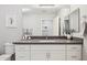 Bathroom with a single sink vanity, large mirror, white cabinets, and a framed botanical print at 17850 N 68Th St # 2138, Phoenix, AZ 85054
