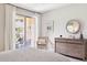 Bedroom featuring dresser and seating near balcony access, letting in ample natural light at 17850 N 68Th St # 2138, Phoenix, AZ 85054