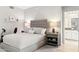 Comfortable bedroom with queen bed, nightstands, ensuite bathroom, and a light gray color palette at 17850 N 68Th St # 2138, Phoenix, AZ 85054