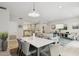Open-concept dining area with a modern table, elegant chairs, and seamless flow into the living spaces at 17850 N 68Th St # 2138, Phoenix, AZ 85054