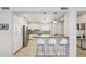 Modern kitchen featuring white cabinets, stainless steel appliances, and a breakfast bar with seating at 17850 N 68Th St # 2138, Phoenix, AZ 85054