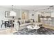Bright living room featuring a modern couch, stylish rug, and open floor plan to kitchen and dining area at 17850 N 68Th St # 2138, Phoenix, AZ 85054