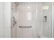 Modern walk-in shower featuring sleek tile, glass door, and convenient grab bars at 17850 N 68Th St # 2138, Phoenix, AZ 85054
