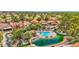 Beautiful aerial view of the community's pool and pond area with lush greenery and palm trees at 19107 N 94Th Ave, Peoria, AZ 85382