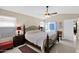 Comfortable bedroom features neutral tones, ceiling fan, stylish furniture, and natural light at 19107 N 94Th Ave, Peoria, AZ 85382