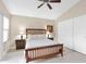 Comfortable bedroom features neutral tones, ceiling fan, stylish furniture, and natural light at 19107 N 94Th Ave, Peoria, AZ 85382