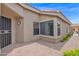 Rear exterior showcasing a stucco finish, brick paver patio, and neat desert landscaping at 19107 N 94Th Ave, Peoria, AZ 85382