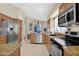 Modern kitchen with stainless steel appliances, granite countertops, and warm wood cabinetry at 19107 N 94Th Ave, Peoria, AZ 85382