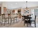 Open kitchen and dining area with granite countertops, modern appliances, and ample seating at 19107 N 94Th Ave, Peoria, AZ 85382