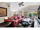 Bright living room boasts vaulted ceilings, ceiling fan, and sliding glass doors to the outdoor patio at 19107 N 94Th Ave, Peoria, AZ 85382