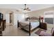 Main bedroom features neutral color palette, ceiling fan, walk-in closet and en suite bathroom at 19107 N 94Th Ave, Peoria, AZ 85382