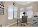 Cozy office space filled with natural light, showcasing a modern desk and tile flooring at 19107 N 94Th Ave, Peoria, AZ 85382