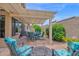Outdoor patio featuring a pergola, comfortable seating and beautiful landscaping at 19107 N 94Th Ave, Peoria, AZ 85382