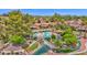 Aerial view showcases a luxurious community pool, lush landscaping, and serene water features at 19107 N 94Th Ave, Peoria, AZ 85382