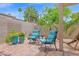 Cozy outdoor sitting area with decorative blue patio chairs and vibrant potted plants at 19107 N 94Th Ave, Peoria, AZ 85382