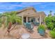 Inviting patio area with pergola, comfortable seating, and beautiful desert landscaping at 19107 N 94Th Ave, Peoria, AZ 85382
