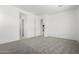 A bright, spacious bedroom with plush carpeting and fresh, white walls, offering a clean and modern aesthetic at 20256 W Monterey Way, Buckeye, AZ 85396