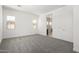 Bright bedroom with neutral carpet, and white walls accented by two windows, offering ample natural light at 20256 W Monterey Way, Buckeye, AZ 85396