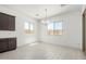 Bright dining area with white walls, tile floors, and a modern chandelier at 20256 W Monterey Way, Buckeye, AZ 85396