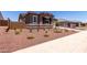 A charming single-story home featuring a well-maintained front yard with fresh landscaping at 20256 W Monterey Way, Buckeye, AZ 85396