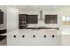 Modern kitchen with white countertops, dark wood cabinets, and stainless steel appliances at 20256 W Monterey Way, Buckeye, AZ 85396