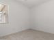 Image of an empty room featuring a window for natural light and stylish tile flooring at 20256 W Monterey Way, Buckeye, AZ 85396