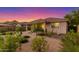 Serene backyard featuring desert landscaping, a covered patio, and a peaceful atmosphere at 20783 W Pasadena Ave, Buckeye, AZ 85396