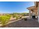 Expansive backyard featuring desert landscaping, gravel, and a covered patio, ideal for outdoor entertaining at 20783 W Pasadena Ave, Buckeye, AZ 85396