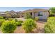 Charming backyard with desert landscaping, including drought-resistant plants and gravel, perfect for low maintenance living at 20783 W Pasadena Ave, Buckeye, AZ 85396