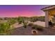 Beautiful backyard with desert landscaping, a covered patio area, and views of the surrounding mountains at 20783 W Pasadena Ave, Buckeye, AZ 85396