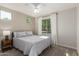 Bright bedroom with neutral walls, carpet, fan, white curtains, and natural lighting at 20783 W Pasadena Ave, Buckeye, AZ 85396
