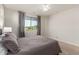 Spacious bedroom with neutral walls, carpet, fan, and natural lighting with a view to the outside at 20783 W Pasadena Ave, Buckeye, AZ 85396