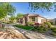 Charming single-story home with beautiful landscaping and a welcoming entrance with a stone archway at 20783 W Pasadena Ave, Buckeye, AZ 85396