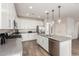 Contemporary kitchen showcasing white cabinetry, stainless steel appliances, and a functional center island at 20783 W Pasadena Ave, Buckeye, AZ 85396