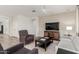 Bright and cozy living room with a flat-screen TV, a ceiling fan, and a light color scheme at 20783 W Pasadena Ave, Buckeye, AZ 85396