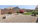 Landscaped backyard featuring a stone ground cover, artificial turf, and beautiful decorative plants at 22964 E Via Del Sol --, Queen Creek, AZ 85142
