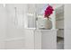 Bright bathroom featuring a shower with a built-in seat and a stylish vanity with fresh flower decor at 22964 E Via Del Sol --, Queen Creek, AZ 85142