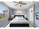 Inviting staged bedroom with a plush bed, ceiling fan, and ample natural light at 22964 E Via Del Sol --, Queen Creek, AZ 85142