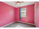 Vibrant bedroom features pink walls, carpet flooring, and a ceiling fan at 22964 E Via Del Sol --, Queen Creek, AZ 85142
