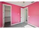 Bedroom with pink walls, carpet flooring, a ceiling fan, and walk-in closet at 22964 E Via Del Sol --, Queen Creek, AZ 85142