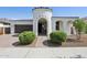 Beautiful stucco home with a turret entrance, complemented by a paved driveway and well-manicured landscaping at 22964 E Via Del Sol --, Queen Creek, AZ 85142