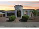 Stunning stucco home featuring a turret entryway, brick driveway, and lush, low-maintenance landscaping at 22964 E Via Del Sol --, Queen Creek, AZ 85142